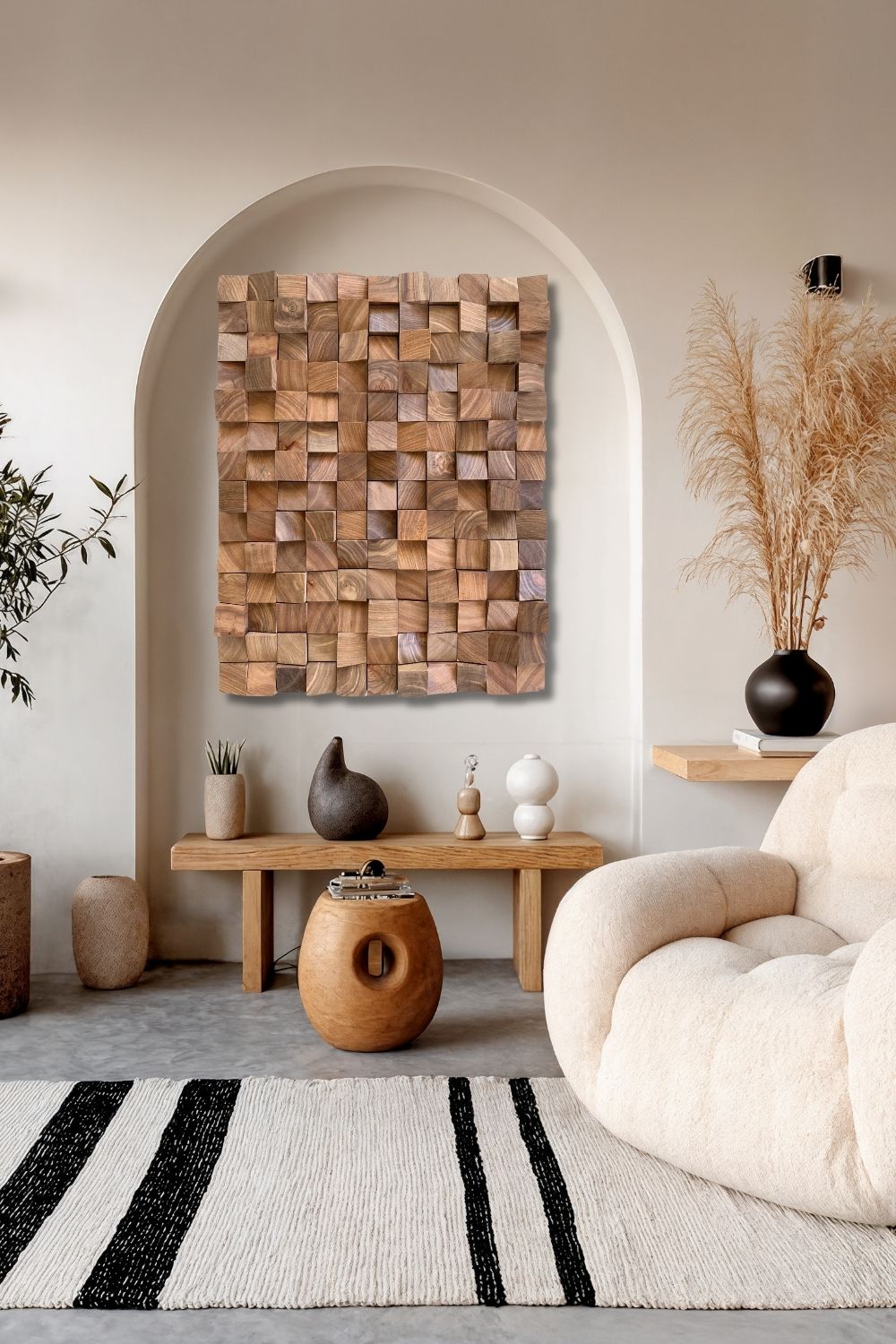 Decorative wooden sound diffuser in a neutral living room with an arched wall niche and cream chair.