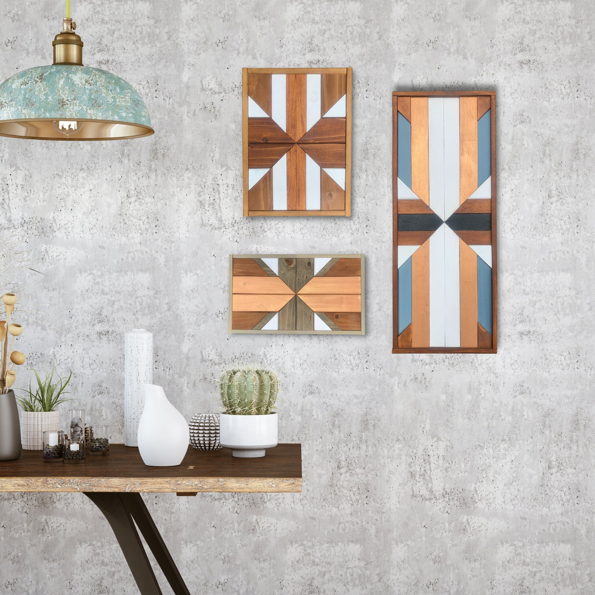 Set of three handmade geometric wall art pieces crafted from stained and painted wood. Each panel features bold, symmetrical patterns in natural tones with white, blue, and bronze accents. Part of the Geometric Wall Art collection.