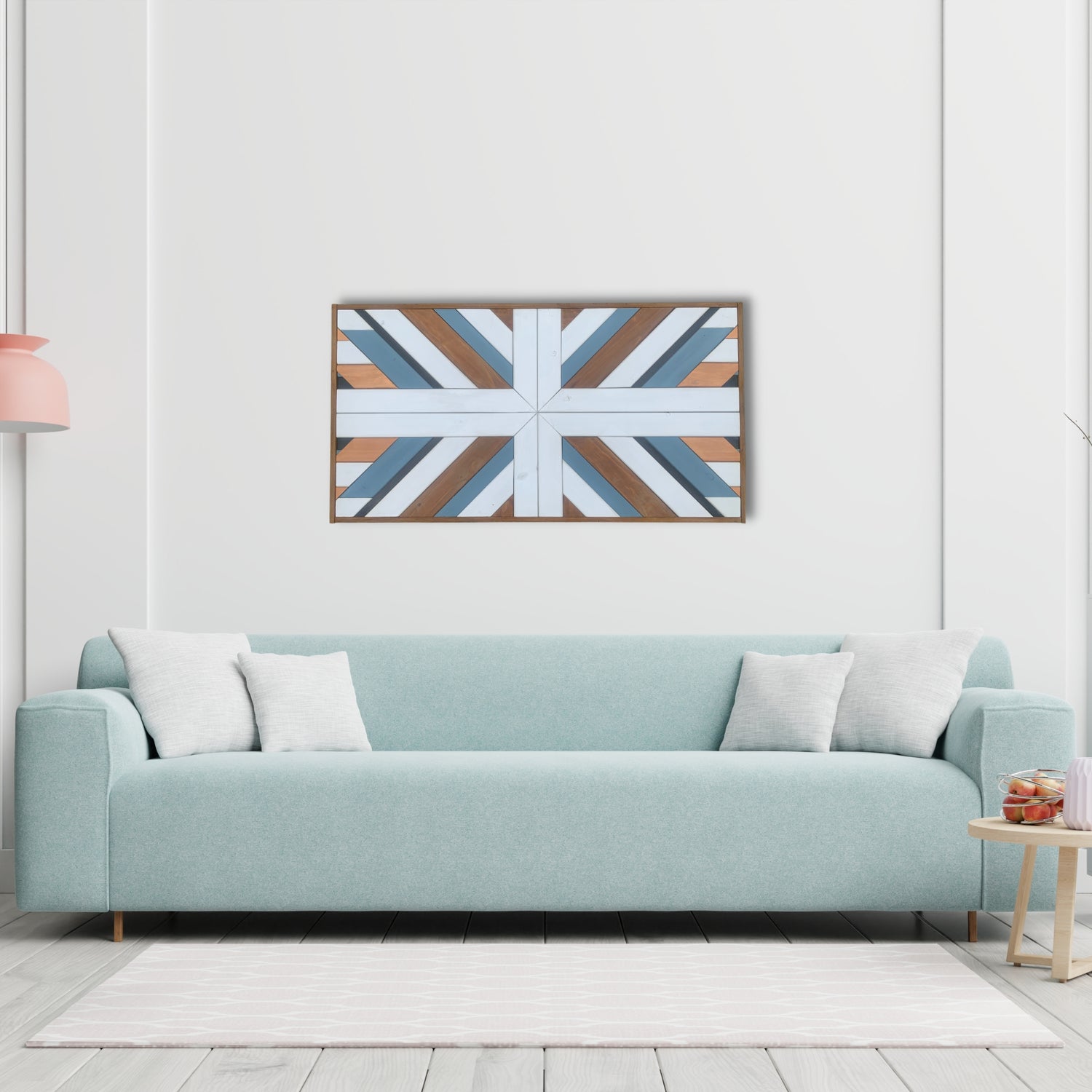 Geometric wooden wall art above a pale blue sofa in a modern neutral interior.