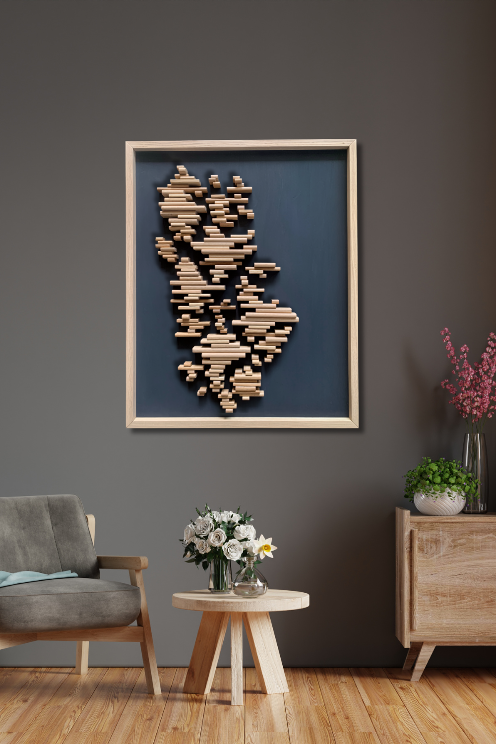 The Rhythm of Life sculptural White Oak wood wall art displayed on a dark grey wall in a contemporary interior.
