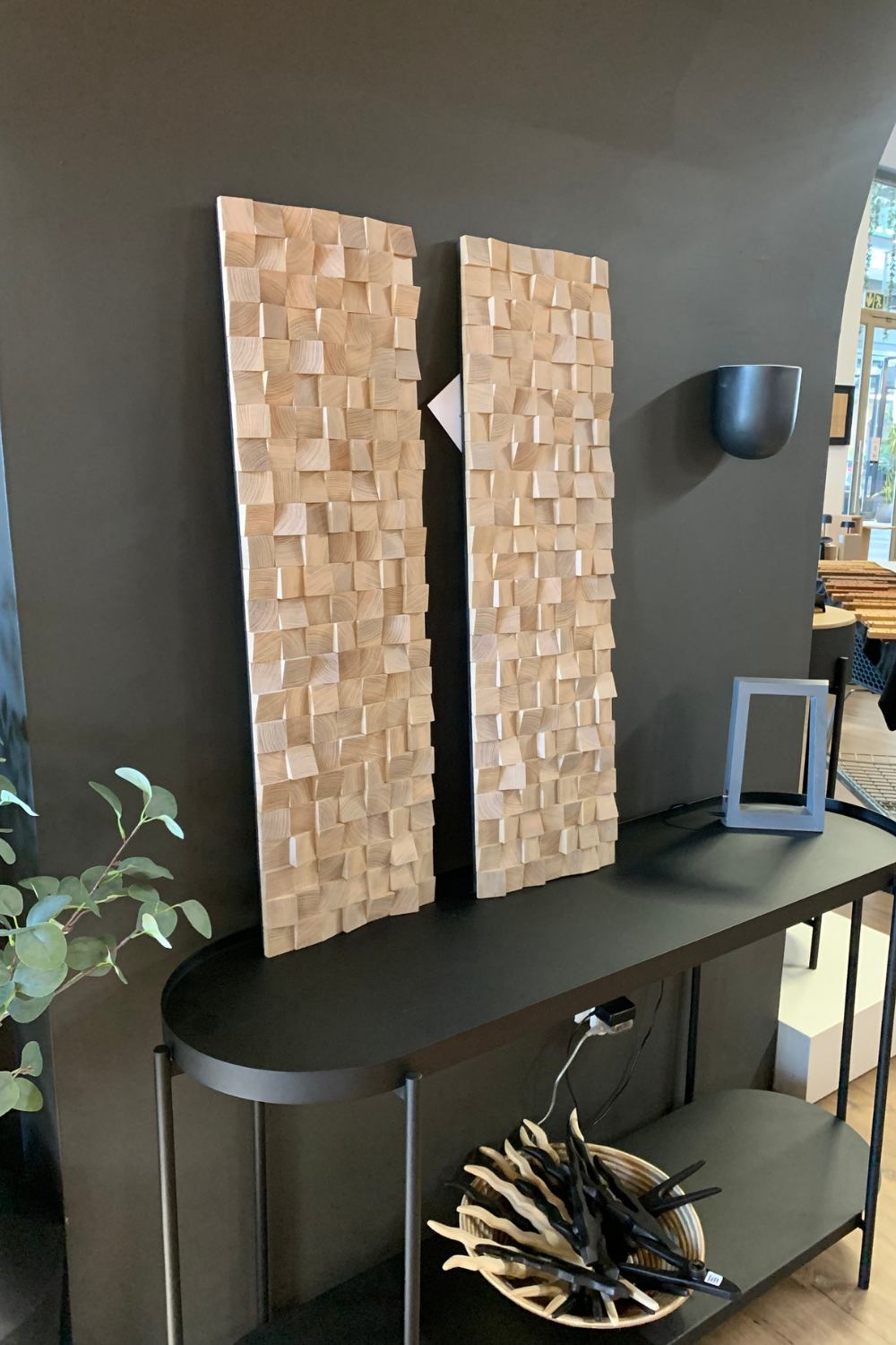 Two handcrafted white oak acoustic-style block wall panels installed in a modern interior, showing raised wood texture and natural timber grain.